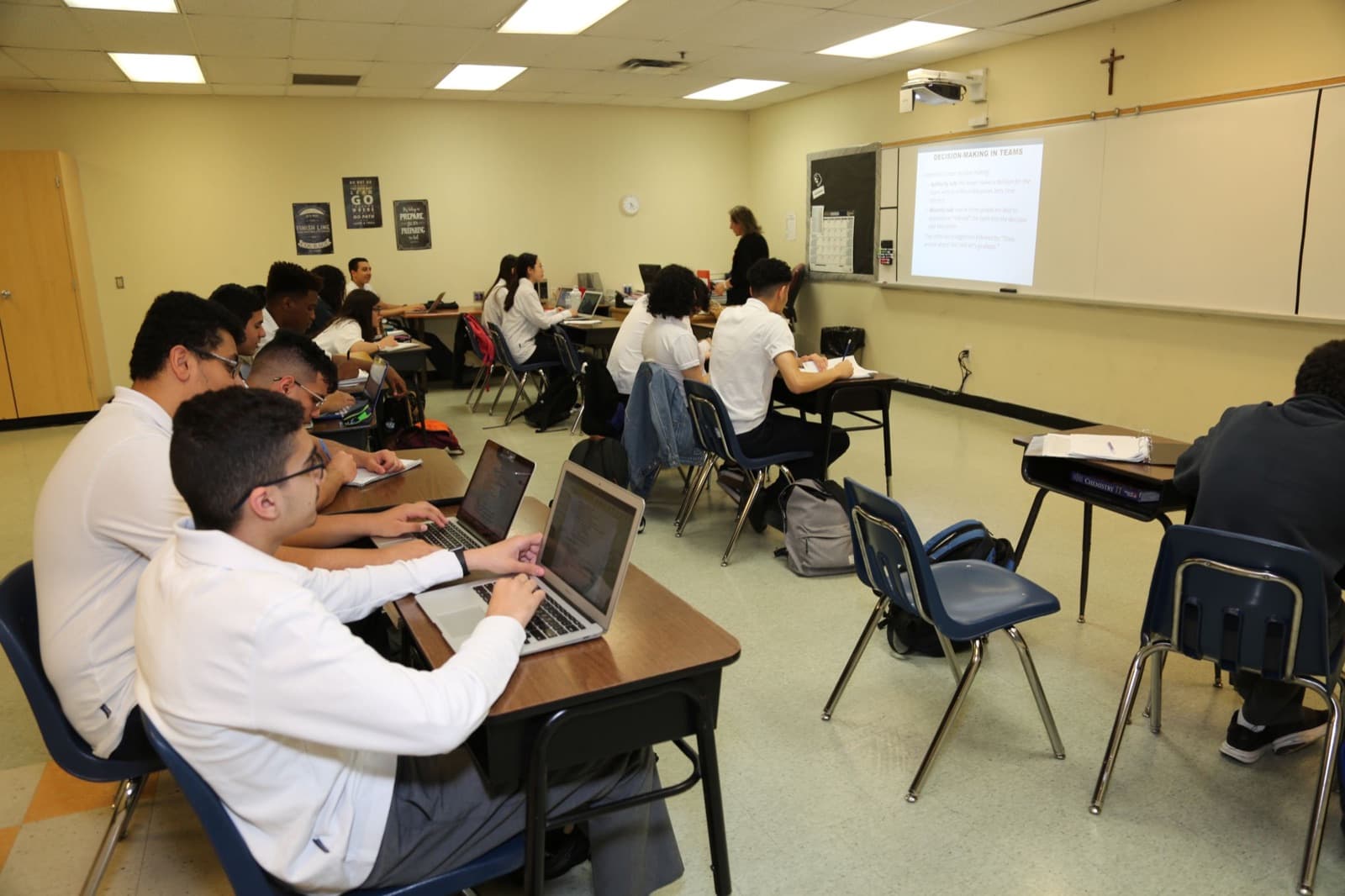 Senior students work on laptops in a classroom at the Mississauga campus.